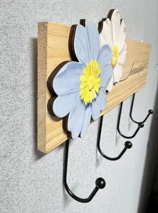 Detailed view of wooden wall hook with 3D floral decoration and sturdy metal hooks.