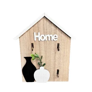 Minimalist wooden house-shaped key holder with decorative vases and three metal hooks