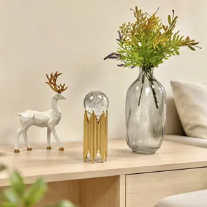 Detailed view of luxury crystal ball ornament with gold iron stand in home setting