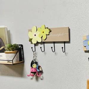 Wooden wall mounted coat rack with yellow floral decor and four hooks for entry, hallway, bedroom.