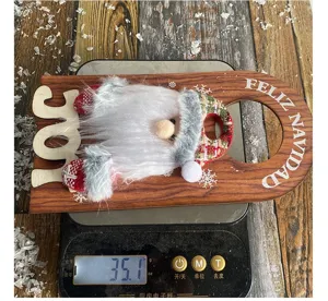 Christmas Santa wooden door hanger on a digital scale showing 35.1g weight detail