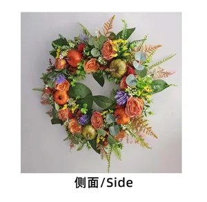 Detailed side view of an artificial autumn floral wreath featuring pumpkins and roses