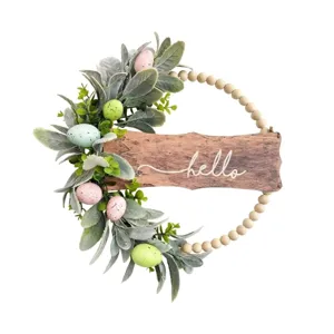 Spring Easter wreath with bunny ear leaves, colorful eggs, and wooden Hello sign