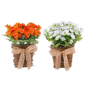 Artificial daisy flower bouquets in woven wicker baskets with burlap bows for home decor
