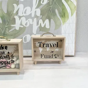 Close-up detail of a Nordic wooden piggy bank with Travel Fund print and transparent glass