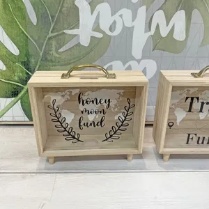 Nordic wooden piggy bank detail with Honey Moon Fund text and world map