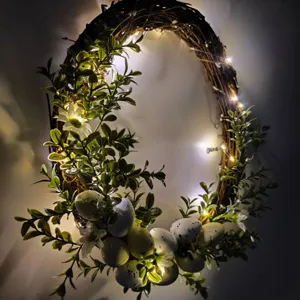 Close-up of artificial Easter wreath with speckled eggs and warm LED fairy lights decor