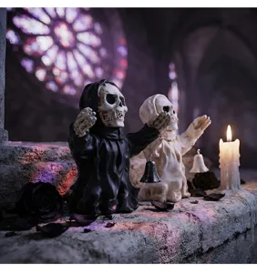 Gothic Halloween skeleton figures in hooded robes with bells on stone ledge