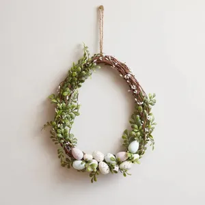 Spring Easter egg wreath with lush green leaves and pastel speckled eggs door decor