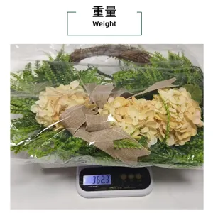 Detailed view of the hydrangea simulation floral wreath on a scale showing a weight of 362.3g