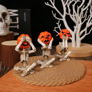 Set of three Halloween pumpkin head skeleton figurines in meditation yoga poses