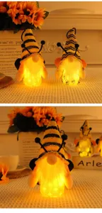 Cute glowing bee festival gnome decoration with warm LED light and fuzzy white beard detail