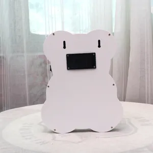 Back view of creative wooden bear LED night light showing battery compartment and wall mount