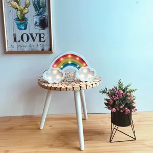 Creative Nordic wooden LED rainbow night light lamp on a rustic stool with floral decor