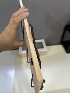 Detailed side view showing the thickness of minimalist solid wood wall-mounted coat rack