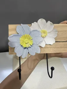 Detail view of a creative solid wood wall hook featuring decorative blue and white flowers.