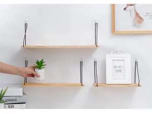 Close-up view of minimalist wall-mounted wooden shelves featuring natural grain detail
