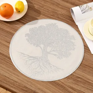Top-down view of a round PVC placemat featuring a detailed white embossed tree design