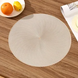 Detailed top view of elegant round gold PVC placemat with a premium spiral texture finish