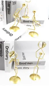 Close-up of decorative gold iron basketball player figurines holding clear crystal balls