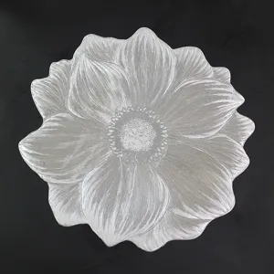 Silver flower-shaped PVC placemat with intricate petal texture and heat resistance.