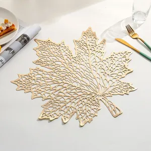 Close-up of a golden maple leaf hollowed PVC heat-resistant placemat for dining table decoration