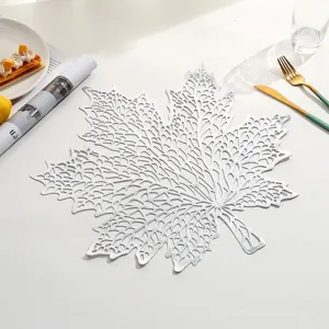Detailed view of a silver leaf-shaped hollow PVC heat-resistant dining table placemat.