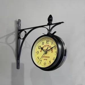 Detailed side view of a vintage double-sided wall clock with ornate black iron bracket