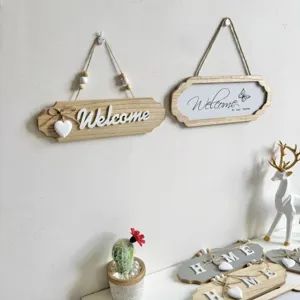 Detail view of rustic wooden 'Welcome' signs with beaded rope hangers