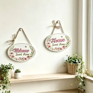 Close-up of two Nordic oval wooden welcome signs with floral design and hemp rope hangers.