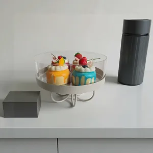 Detail view of dessert stand with cakes inside transparent acrylic cover
