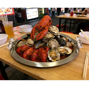 Durable stainless steel oval tray with handles showcasing a large seafood platter display
