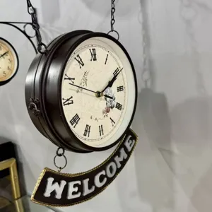 Detail of vintage European style double-sided wall clock with metal Welcome sign