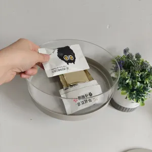 Detailed view of clear acrylic snack storage display tray being filled with treats