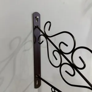 Detailed view of vintage European iron wall bracket mounting system on light wall