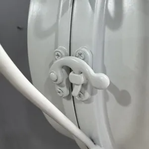 Macro detail of white wrought iron latch mechanism on retro double-sided wall clock.
