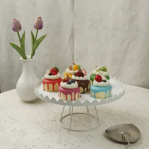 Elegant white metal cake stand with scalloped edge for dessert display and wedding decor