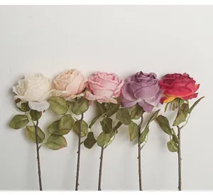 Detailed macro view showing five multi-colored artificial roses with realistic burnt edge textures