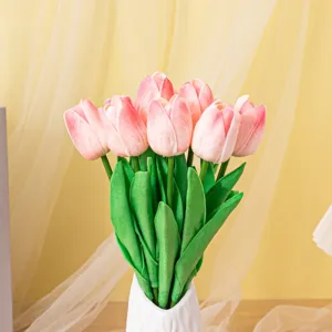 Close-up of artificial pink tulips in a white ceramic vase for home decor