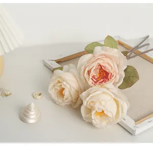 Close-up of French romantic artificial roses with burnt edges in a vintage interior scene
