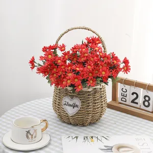 Macro shot of vibrant red artificial daisies in a rustic woven basket for home decoration.