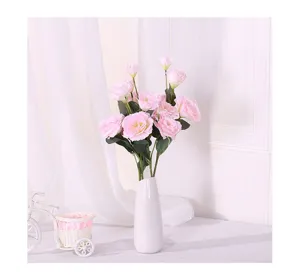 Elegant pink artificial Lisianthus flowers in a white minimalist vase for home decor