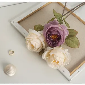 Detail of realistic artificial roses with burnt edge effect in cream and purple colors.