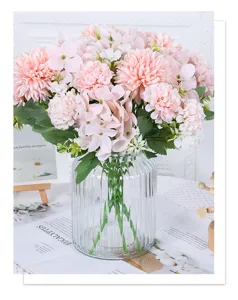 Detailed view of pink artificial flower bouquet in a clear fluted glass vase