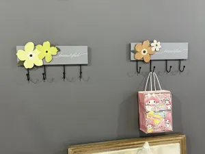 Decorative wooden wall coat rack with 3D flower accents and four black metal hooks