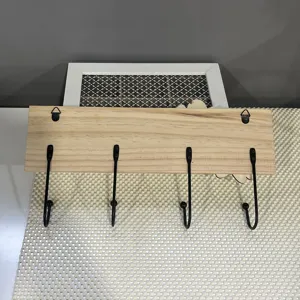Detailed view of the solid wood wall-mounted coat rack with 4 black metal hooks