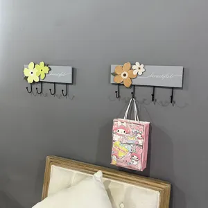Minimalist wooden wall-mounted coat rack with 4 hooks and decorative floral elements