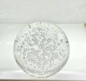 Detailed macro view of a decorative clear crystal ball ornament with unique air bubbles inside