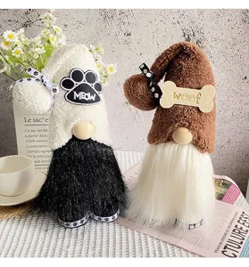 Close-up detail of plush pet-themed gnomes with 'Meow' and 'Woof' paw bone embroidery