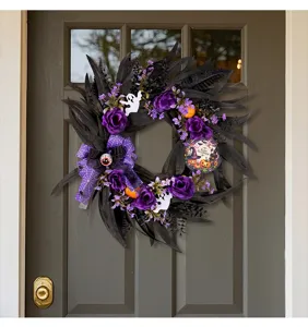 Detailed macro view of a Halloween wreath featuring purple roses and spooky ghost accents